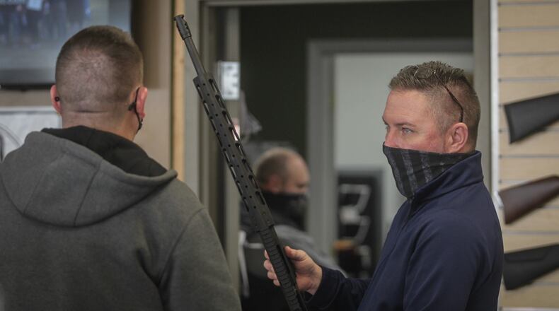 David Becker, owner of Miami Armory gun shop near the Dayton Mall, talks to a customer Thursday Jan. 14, 2021.Becker said the new gun owners are from all walks of life. His shop has seen more women shooters in recent years. Becker said recently he has seen people who would generally be anti-gun come into his shop. JIM NOELKER