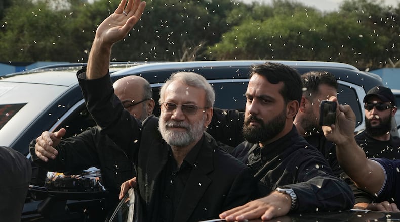 FILE - Ali Larijani, center, head of Iran's National Security Council, gestures as Hezbollah supporters throw rice to welcome him outside Rafik Hariri International Airport in Beirut, Lebanon, Wednesday, Aug. 13, 2025. (AP Photo/Bilal Hussein, File)