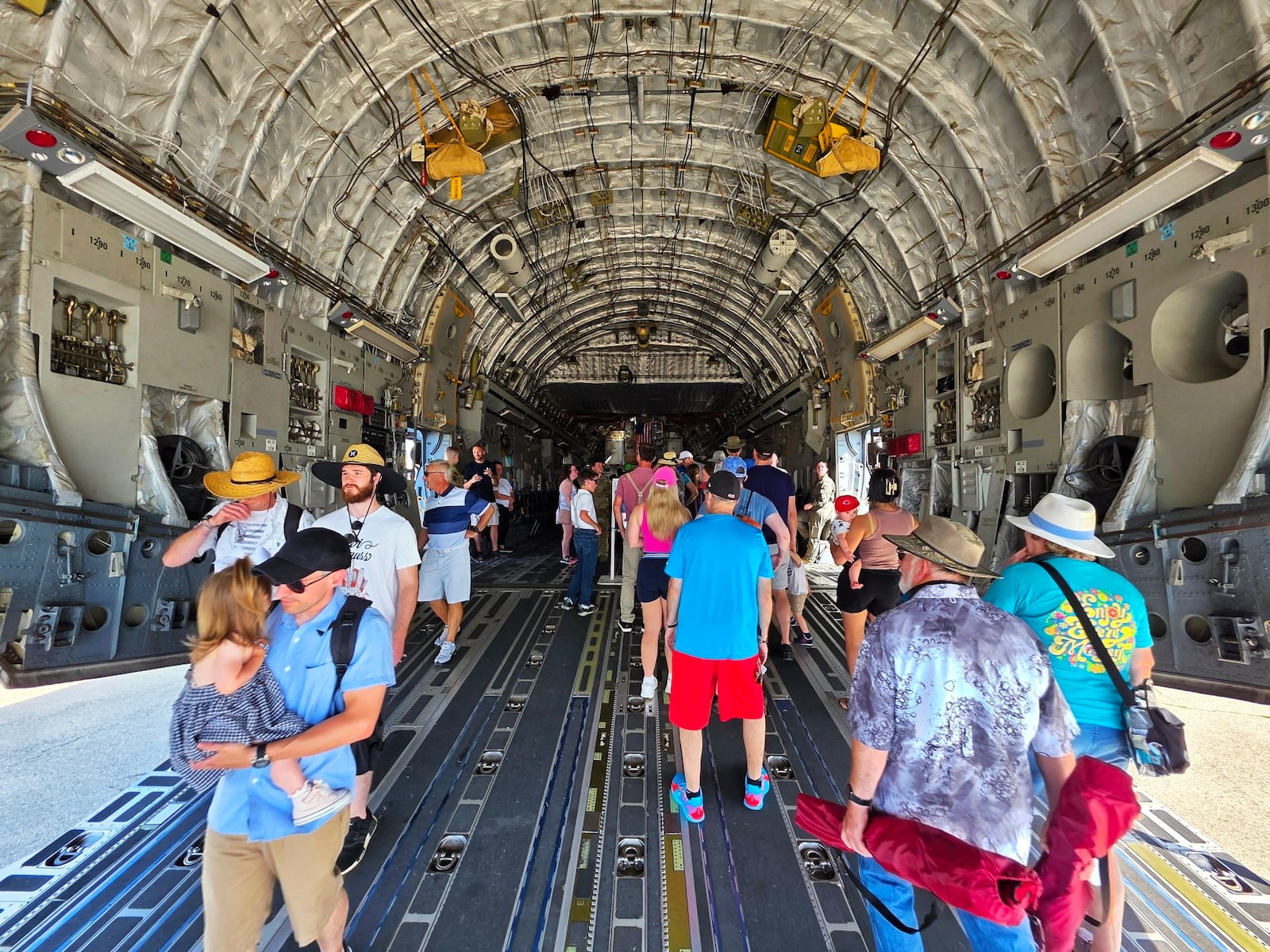 Visitors walk inside a C-17 Globemaster during the CenterPoint Energy Dayton Air Show Saturday, June 21, 2025 at Dayton International Airport. NICK GRAHAM/STAFF