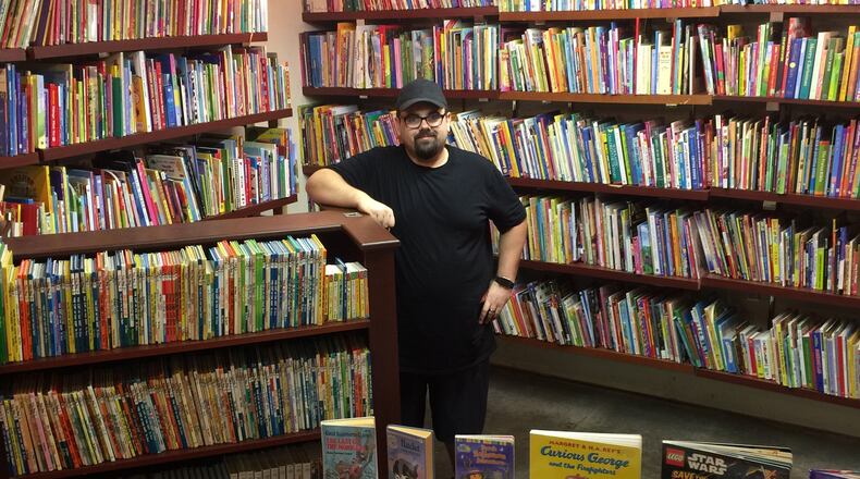 Greg Murphy in the children’s book room of One Dollar Book Swap, which opened in July. CONTRIBUTED