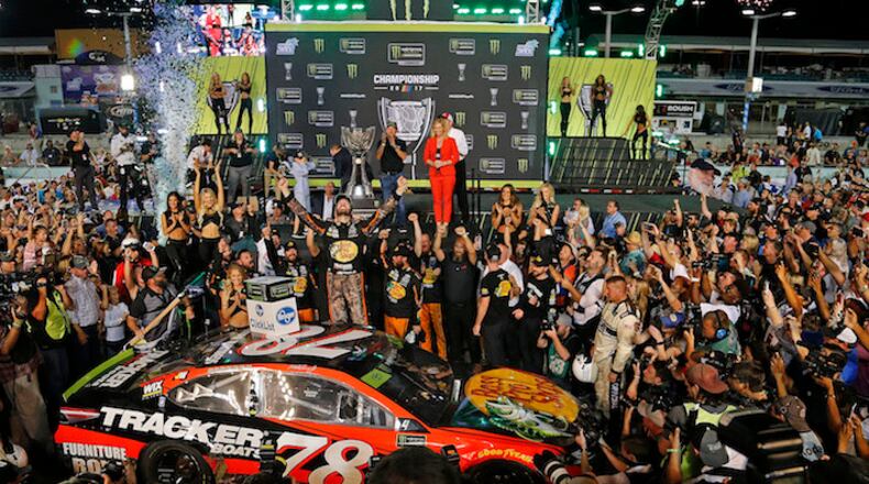 Martin Truex Jr., celebrates as he wins the Monster Energy NASCAR Cup Series Championship and EcoBoost 400 on November 19, 2017, at the Homestead-Miami Speedway in Homestead, Fla. (Carl Juste/Miami Herald/TNS)