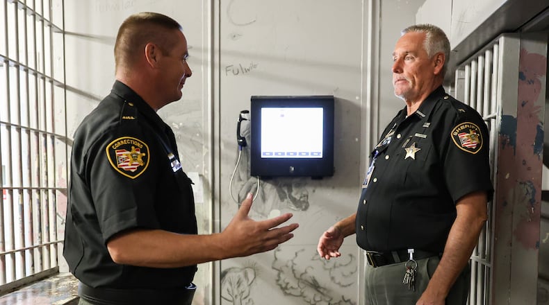 Miami County Sherrif Dave Duchak (right) talks with assistant jail administrator Nate Collett in a cell block in in the Miami County Jail, the county's maximum security facility in the safety building in downtown Troy. BRYANT BILLING / STAFF