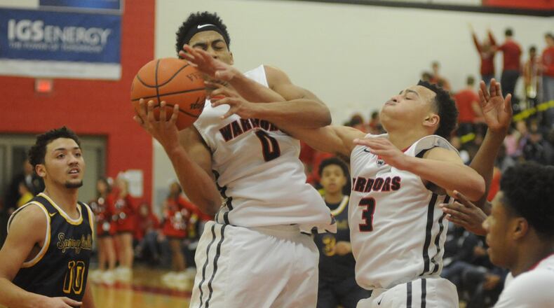 Wayne’s Isaiah Trice secures a rebound with the help of teammate Darius Quisenberry. Springfield defeated host Wayne 56-54 in a boys high school basketball game on Friday, Feb. 10, 2017. MARC PENDLETON / STAFF