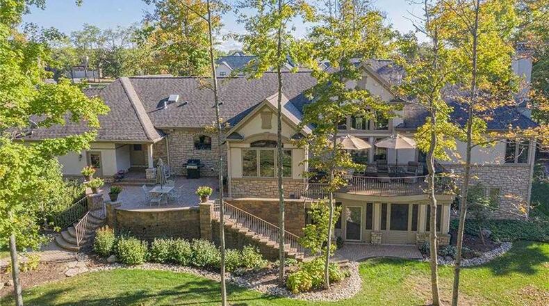 The back of the home allows for private outdoor enjoyment with a paver-brick patio that has two apron staircases that lead down to the back yard and a wood-composite deck accessible from the main bedroom.