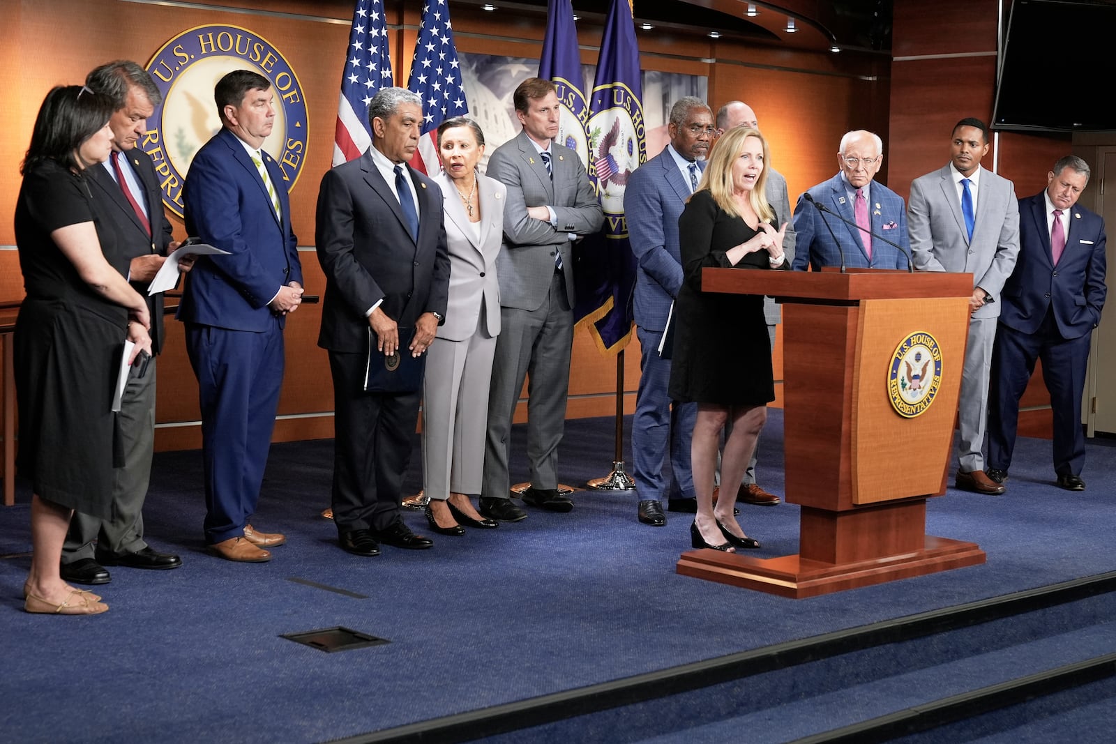 Rep. Madeleine Dean, D-Pa., center, speaks during a news conference at the U.S. Capitol, Wednesday, July 2, 2025, in Washington. (AP Photo/Mariam Zuhaib)