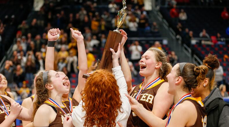 The Alter High School girls basketball team hoists the trophy after beating Thornville Sheridan 54-38 on Saturday afternoon at UD Arena to win its first state championship since 2017. CONTRIBUTED PHOTO BY MICHAEL COOPER