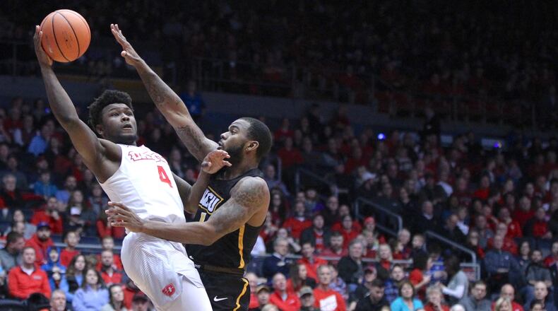 Dayton’s Jordan Davis scores and is fouled by Virginia Commonwealth’s Mike’l Simms on Friday, Jan. 12, 2018, at UD Arena. David Jablonski/Staff