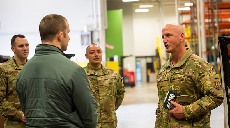 Chief Master Sgt. David Flosi, Air Force Materiel Command command chief, and Kevan Dilworth, 88th Air Base Wing Base Plans and Programs Division mission operations specialist, discuss the capabilities of the Android Tactical Assault Kit (ATAK), Mar. 10, 2022, during a visit to Wright-Patterson Air Force Base, Ohio. ATAK and similar common operating picture technology enhance command and control of emergency situations and allow for multi-agency integration. (U.S. Air Force photo by Jaima Fogg)