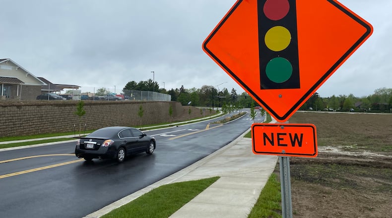 A Miami Twp. infrastructure project that extended Vienna Parkway 650 feet west to Ohio 741 opened Monday, May 3, 2021, following a ceremonial ribbon-cutting ceremony. The $1.6 million project, which included installation of a traffic signal and crosswalks, is aimed at improving safety and spurring economic development. ERIC SCHWARTZBERG/STAFF
