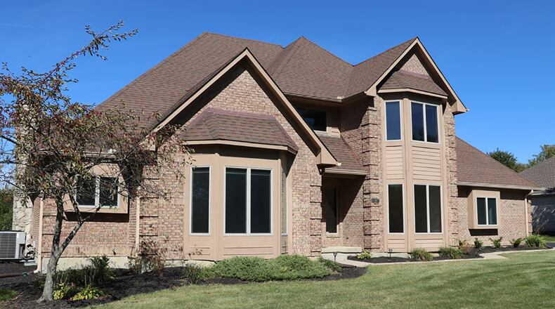 The brick 2-story has 4 bedrooms and about 3,740 sq. ft. of living space plus a full, semi-finished basement. The house sits on just over an acre lot, and the 3-car, side-entry garage has extra parking along the paved drive. CONTRIBUTED PHOTO BY KATHY TYLER