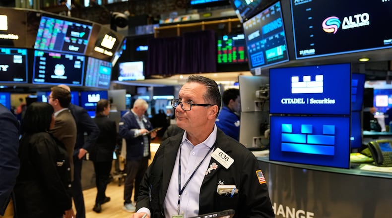 Edward Curran works on the floor at the New York Stock Exchange in New York, Tuesday, Nov. 11, 2025. (AP Photo/Seth Wenig)