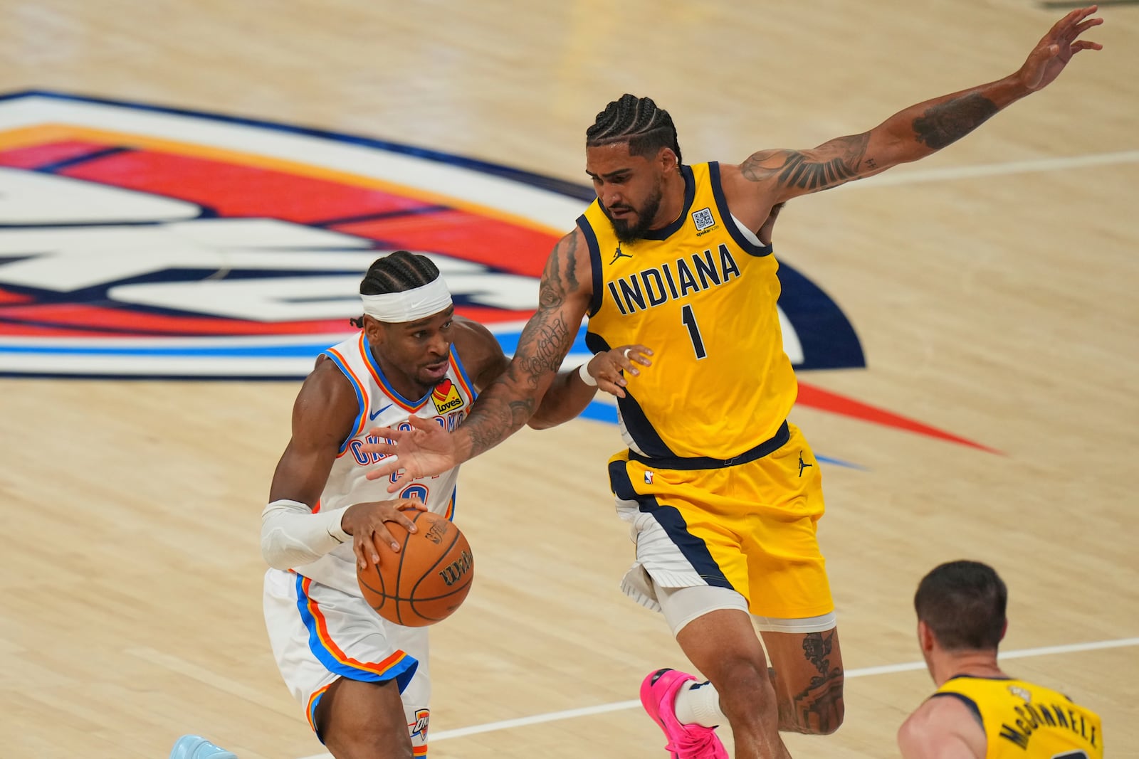 Oklahoma City Thunder guard Shai Gilgeous-Alexander, left, drives as Indiana Pacers forward Obi Toppin (1) defends during the second half of Game 5 of the NBA Finals basketball series, Monday, June 16, 2025, in Oklahoma City. (AP Photo/Nate Billings)