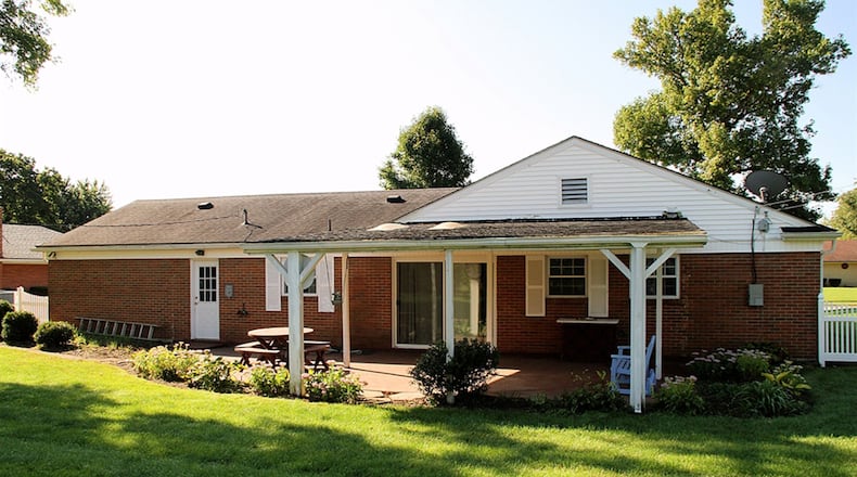 Patio doors off the combination breakfast room and family room open out to a concrete patio, part of which is covered with two skylights. The back yard is fenced with chain-link and vinyl fence. There is also a storage shed.
