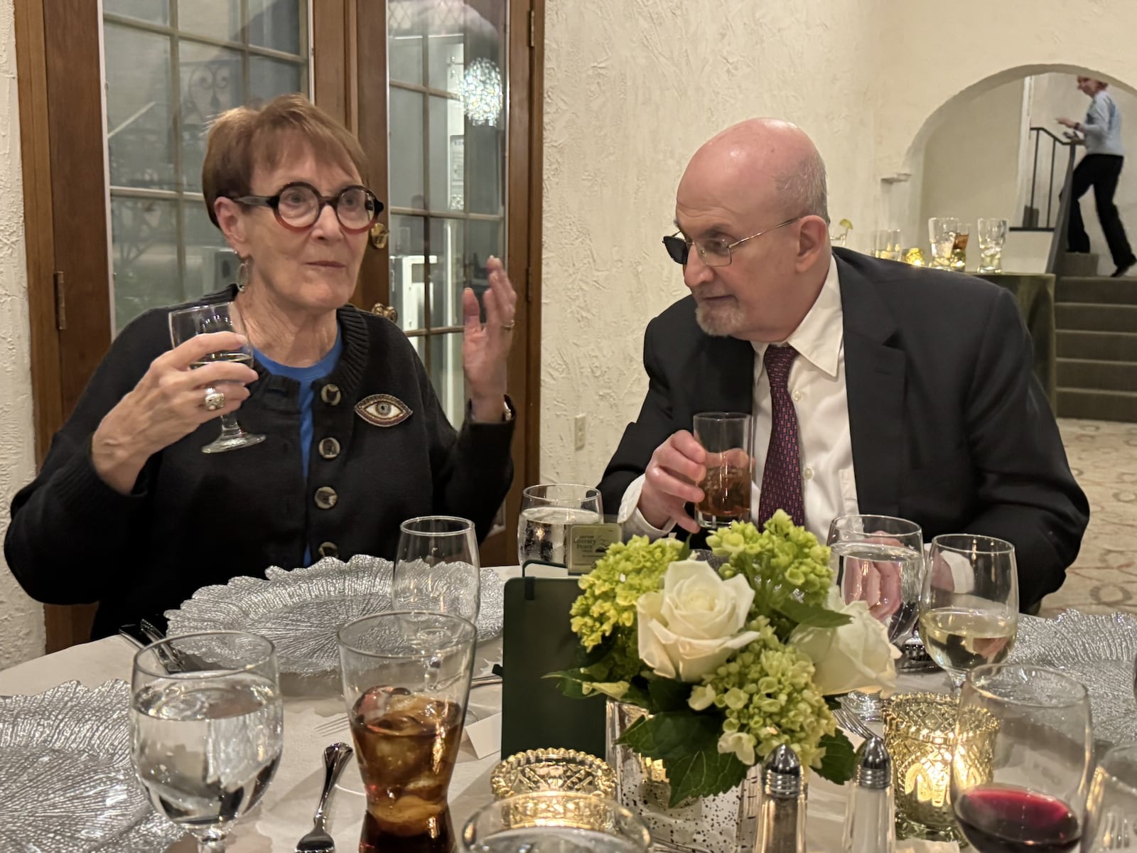 Because of his towering literary reputation, Linda Lombard of Kettering (left) felt a bit apprehensive when she learned she would be sitting next to Salman Rushdie at a private dinner party at the home of University of Dayton President Eric Spina and his wife, Karen, honoring this year’s winners of the Dayton Literary Peace Prize. “But he was so much fun to talk to, and he has a great sense of humor,” Lombard said of Rushdie. “He is a very charming person.” Mary McCarty / CONTRIBUTED