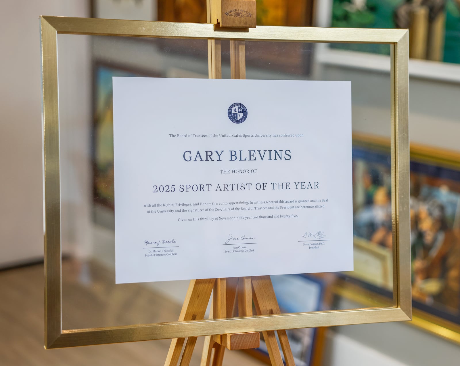 Gary Blevin's award for 2025 Sports Artist of the Year by the United States Sports University sits in his art gallery on Thursday, December 18, 2025, in Springfield. JOSEPH COOKE/STAFF