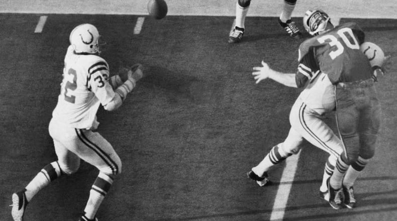 Mike Curtis (32) makes a key interception in Super Bowl V after Dan Reeves (30) was hit by Jerry Logan. The pick enabled the Colts to win the game, 16-13, against Dallas.