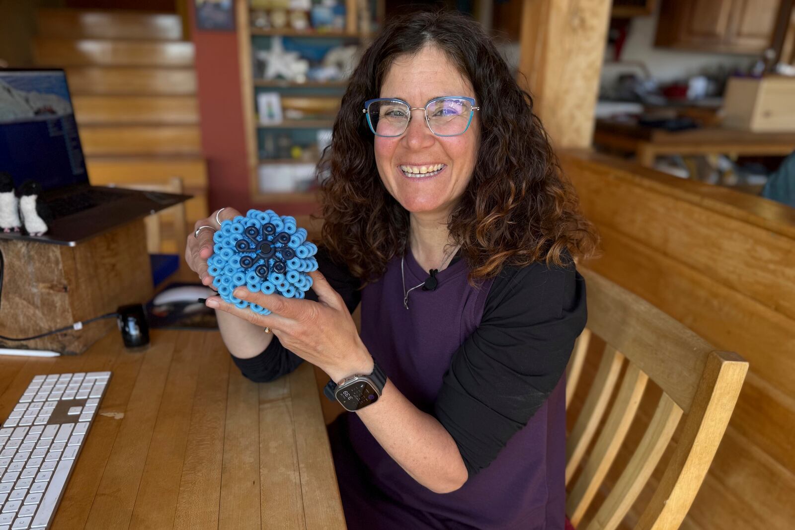 Rachael Z. Miller, founder of the Vermont-based Rozalia Project for a Clean Ocean, displays a Cora Ball, a laundry ball that can be tossed into the washer to cut down on clothes banging into each other and also catches microfibers, on Thursday, April 17, 2025, in Granville, Vt. (AP Photo/Amanda Swinhart)