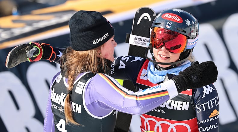 Germany's Emma Aicher, left, and United States' Mikaela Shiffrin hug each other at the finish area of an alpine ski, women's slalom race, at the Lillehammer World Cup Finals, in Hafjell, Norway, Tuesday, March 24, 2026. (AP Photo/Marco Trovati)