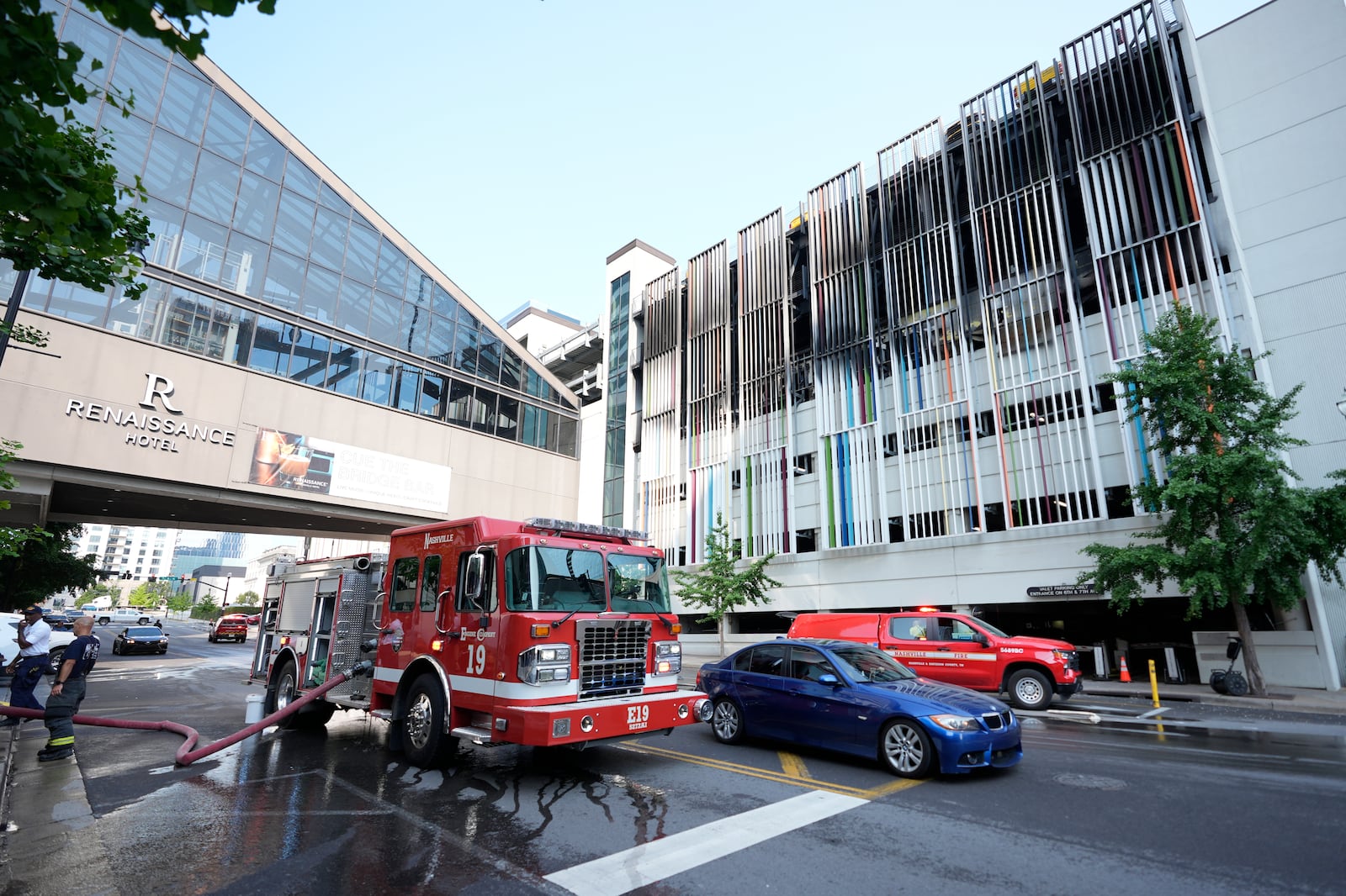 A fire truck is seen outside a parking garage where vehicles caught fire and part of a floor in the structure collapsed Tuesday, June 10, 2025, in Nashville, Tenn. (AP Photo/George Walker IV)