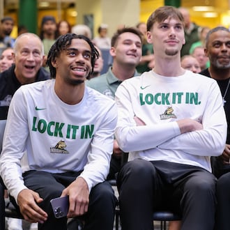 From left to right, Wright State's Michael Cooper, TJ Burch and Kellen Pickett react to a selection during a Selection Sunday watch party on Sunday, March 15 at the university's Student Union in Fairborn. BRYANT BILLING / STAFF