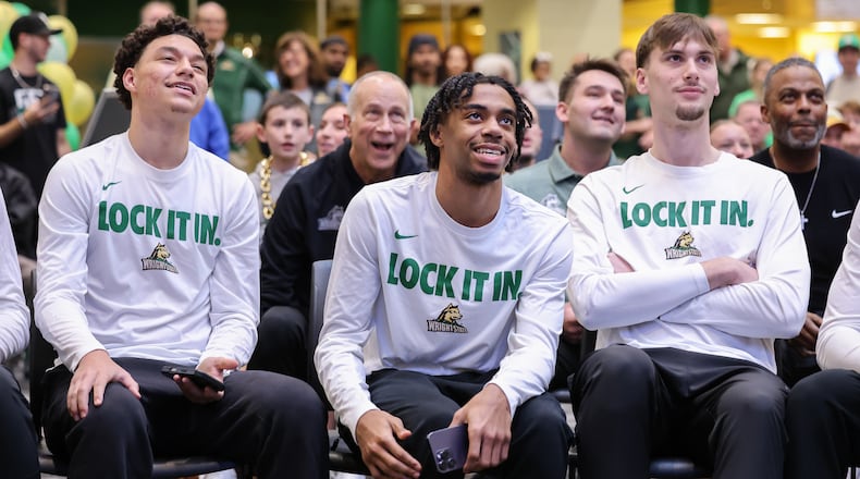 From left to right, Wright State's Michael Cooper, TJ Burch and Kellen Pickett react to a selection during a Selection Sunday watch party on Sunday, March 15 at the university's Student Union in Fairborn. BRYANT BILLING / STAFF