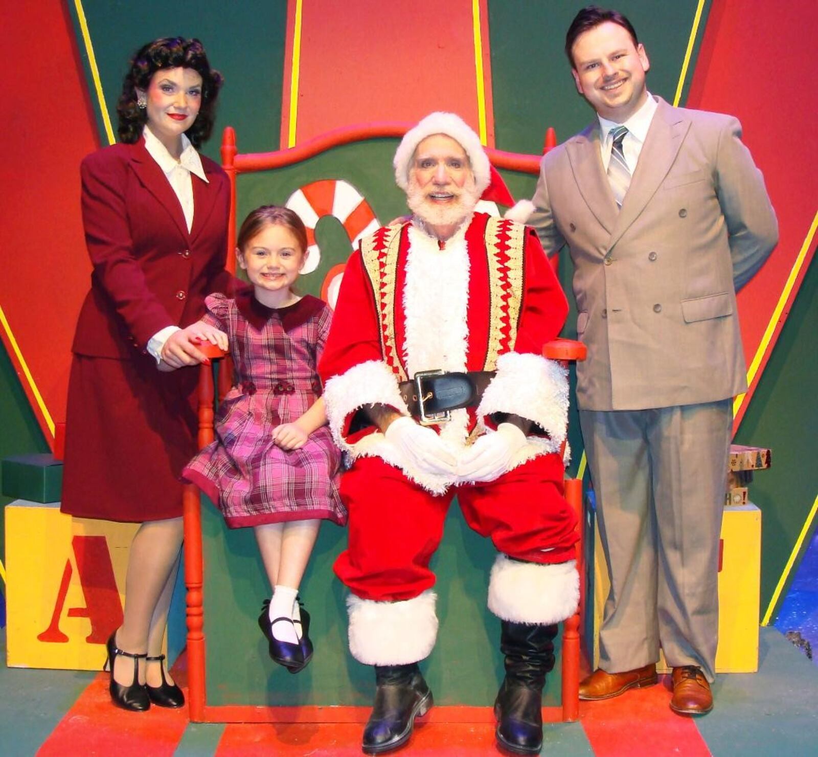 (Left to right): La Comedia Dinner Theatre's production of "Miracle on 34th Street: The Musical" features Rebecca Lea Evans (Doris), Adilynn Hatton (Susan), Jonathan Fluck (Kris Kringle), and Keenan Patrick Buckley (Fred). PHOTO BY JUSTIN WALTON