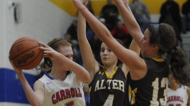 Carroll’s Sydney Ingram (with ball) is cut off by Alter’s Lauren Lush (4) and Olivia Gillis. Alter defeated Carroll 55-38 in a girls high school basketball D-II regional final at Springfield on Friday, March 10, 2017. MARC PENDLETON / STAFF