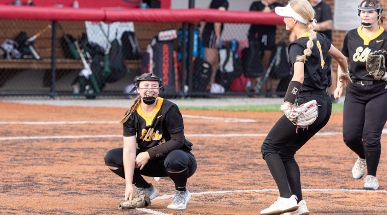 Centerville pitcher Hayley Arnold looks up as second baseman Jenna Kirkpatrick (1) and third baseman Lillie Hopf approach her for the postgame celebration after the Elks defeated Mason 10-1 to advance to the program's first region final. Jeff Gilbert/CONTRIBUTED