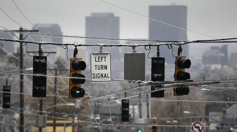 Ice covered trees, poles, wires and traffic signals along Wayne Avenue in Dayton on Thursday morning after freezing rain cancelled school and knocked out power for many. TY GREENLEES / STAFF