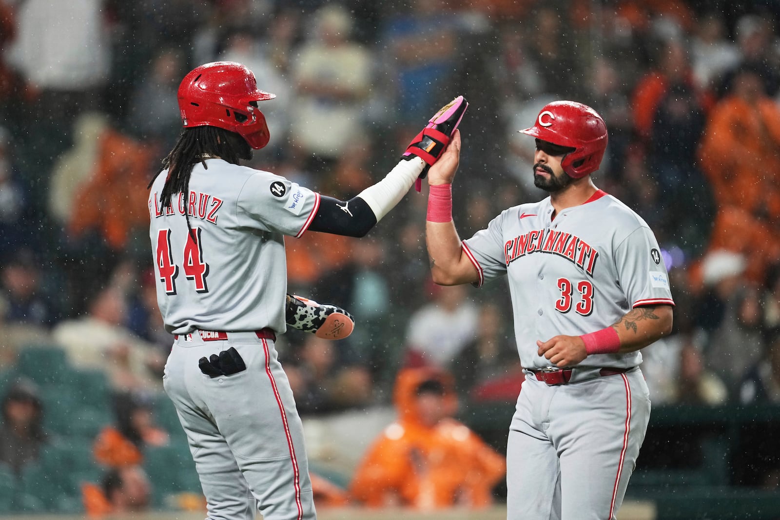 Cincinnati Reds' Elly De La Cruz (44) and Christian Encarnacion-Strand (33) celebrate scoring against the Detroit Tigers in the ninth inning during a baseball game, Friday, June 13, 2025, in Detroit. (AP Photo/Paul Sancya)