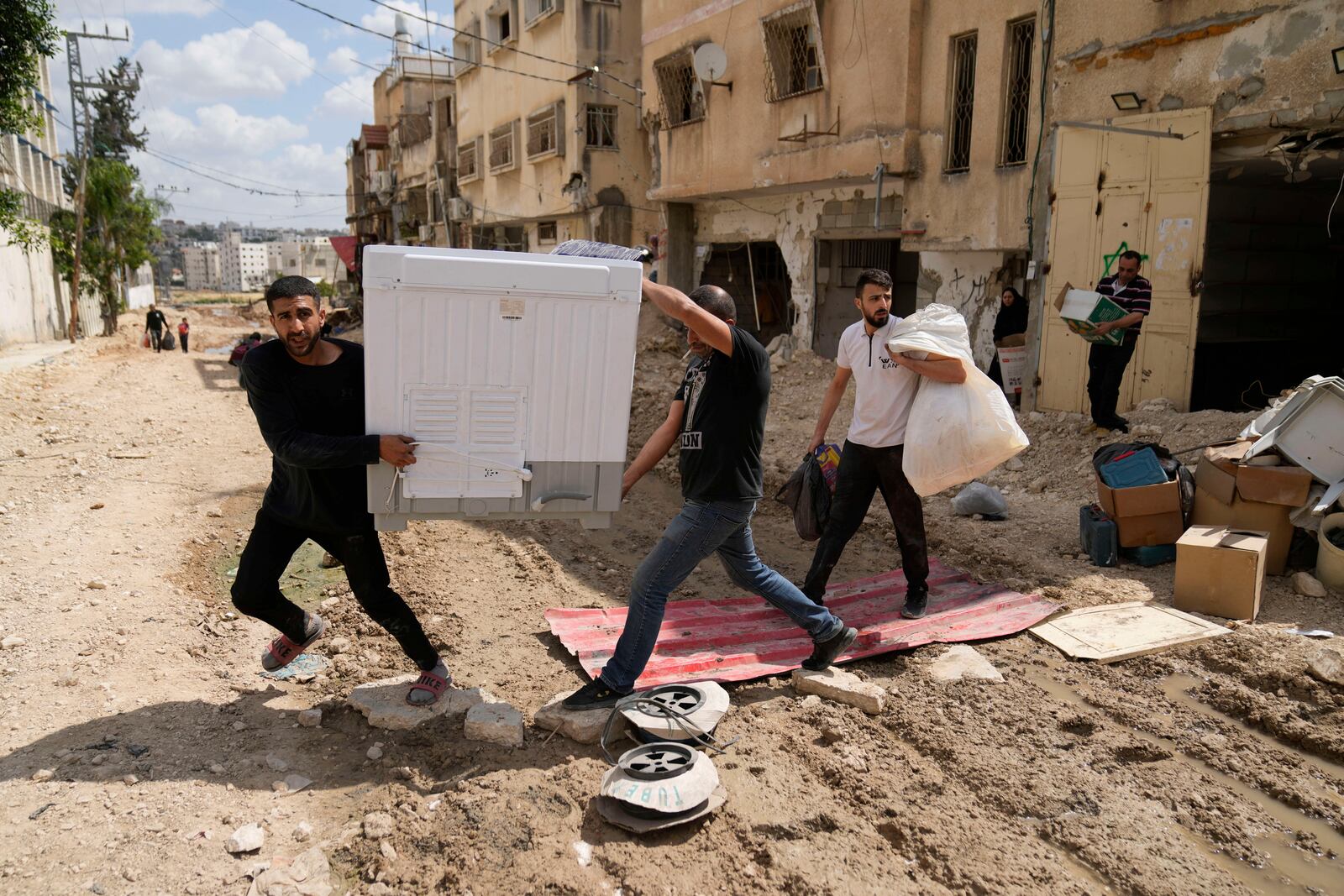 Residents of the now evacuated refugee camp of Tulkarem return to collect belongings before the destruction of their homes as Israeli forces prepare to carry out the demolition of 116 homes across the two refugee camps of the Israeli occupied West Bank city of Tulkarem, Friday, May 2, 2025. (AP Photo/Nasser Nasser)