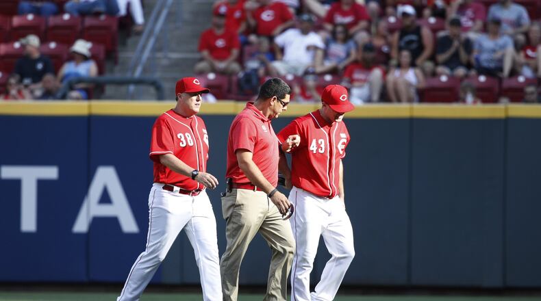Scott Schebler of the Cincinnati Reds leaves the game after being injured making a diving catch in right field in the sixth inning of a game against the Atlanta Braves at Great American Ball Park on June 3, 2017 in Cincinnati, Ohio. The Braves defeated the Reds 6-5 in 12 innings. (Photo by Joe Robbins/Getty Images)