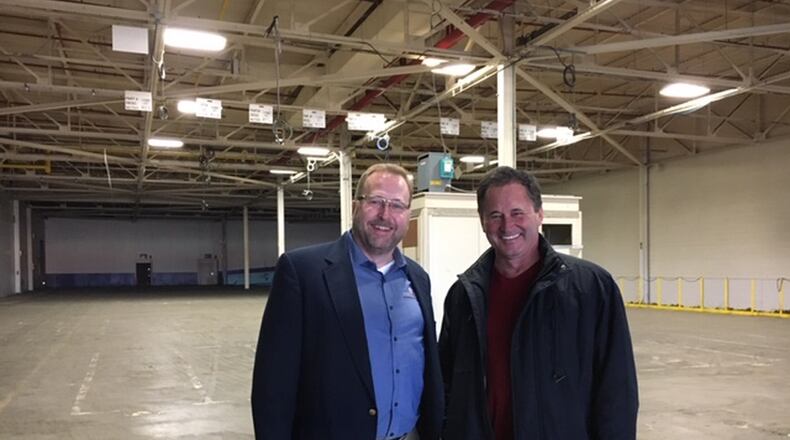 From left, John Busbee, chief executive of Xerion Advanced Battery Corp., and Martin Rucidlo, Xerion director of operations, inside a large bay in the former Delphi Northwoods Boulevard plant, a plant now owned by Xerion. Busbee envisions having perhaps 1,200 employees in the plant in five years. THOMAS GNAU/STAFF