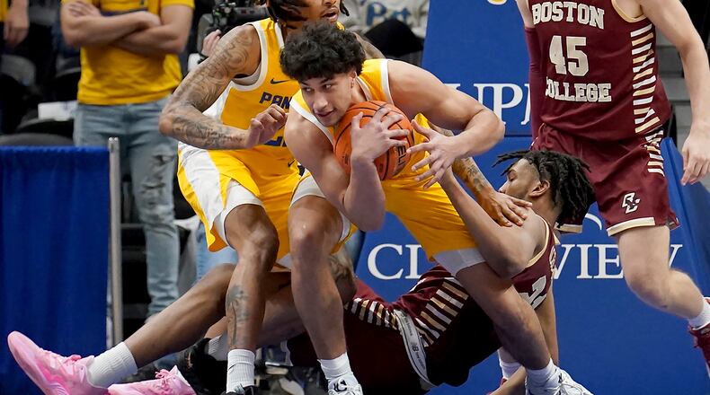 Pittsburgh forward Nate Santos (5) pulls in a loose ball against Boston College forward Devin McGlockton (21) during the second half of an NCAA college basketball game in Pittsburgh, Tuesday, Feb. 14, 2023. Pittsburgh won 77-58. (AP Photo/Matt Freed)