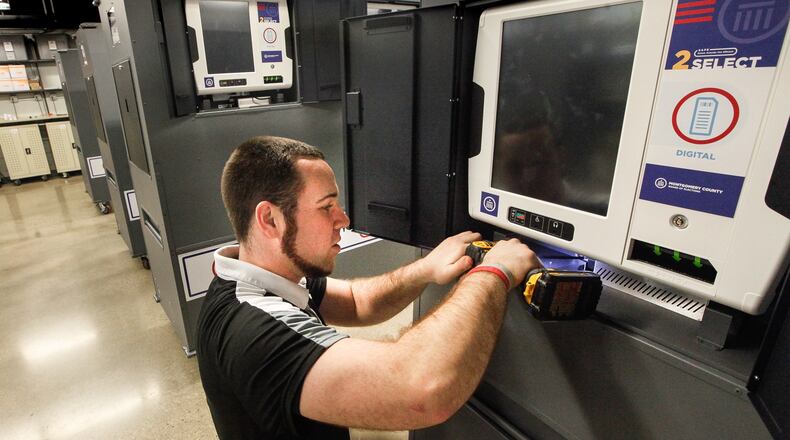 Nick Latessa, an election operations specialist at the Montgomery County Board of Elections, adds a bracket to secure a power cord within a voting machine safe on Friday, Jan. 31, 2020. Ohio elections boards were required to meet a number of requirements spelled out in a secretary of state directive to ensure election integrity. CHRIS STEWART / STAFF