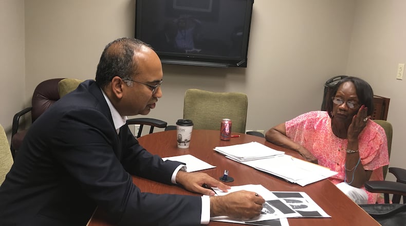 Nirmal Veeramachaneni, a thoracic surgeon at the University of Kansas Hospital, goes over Bettye Givens’ lung scans. Givens, from south Kansas City, had a low-dose CT scan that detected her lung cancer at its earliest stage and was successfully treated. Other smokers don’t have access to the test because not all doctors know about it and Medicare only covers it for health centers that meet stringent requirements. (Andy Marso/Kansas City Star/TNS)