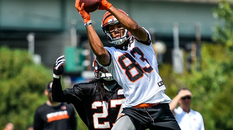Wide receiver Tyler Boyd makes a jumping catch defended by Dre Kirkpatrick during the first day of Cincinnati Bengals Training Camp Friday, July 28 at the practice fields beside Paul Brown Stadium in Cincinnati. NICK GRAHAM/STAFF