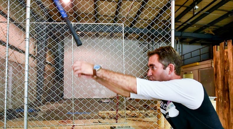 Marty Parker with Cincinnati Axe Throwing demonstrates how to throw an axe at their new location at 4814 Peter Place just off of Ohio 747 in West Chester Township. An entertainment venue that includes Ax throwing is planned for the Fire Blocks District. NICK GRAHAM/STAFF