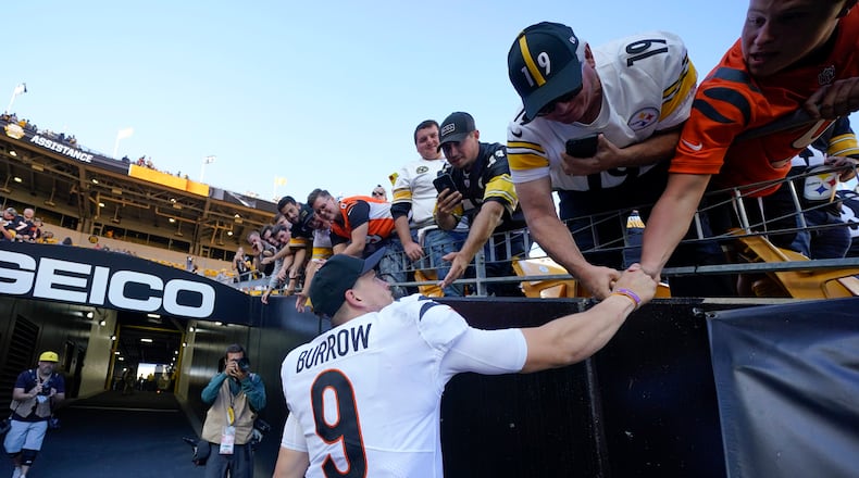 Cincinnati Bengals quarterback Joe Burrow (9) greets fans after defeating the Pittsburgh Steelers in an NFL football game, Sunday, Sept. 26, 2021, in Pittsburgh. The Bengals won 24-10. (AP Photo/Gene J. Puskar)