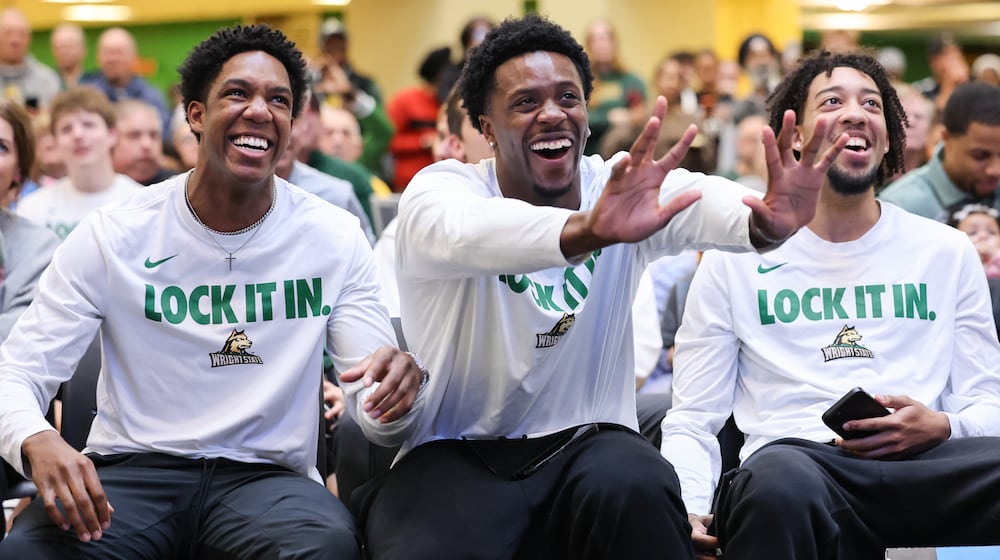 Wright State graduate senior guard Sam Alamutu (center) reacted to an opponent being announced for Gonzaga during a Selection Sunday watch party on Sunday, March 15 at the university's Student Union in Fairborn. BRYANT BILLING / STAFF