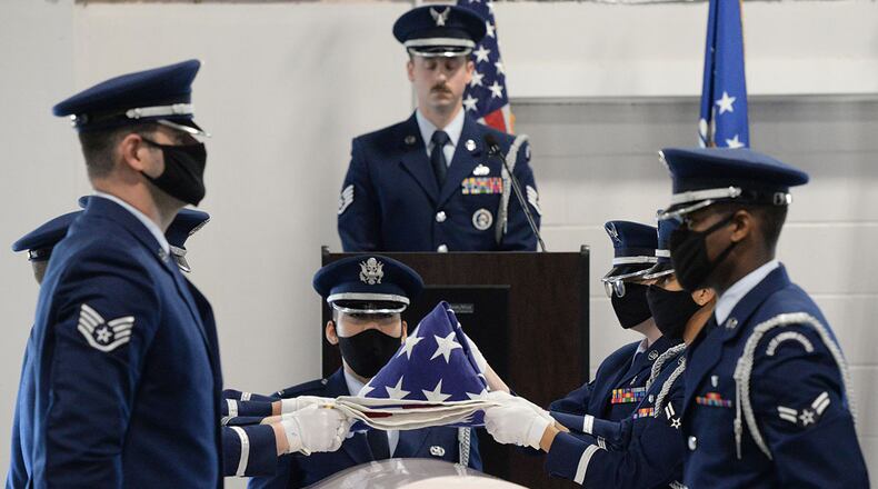 Air Force ceremonial guardsmen demonstrate the six-man flag fold over a casket during the graduation ceremony of 28 new members at Wright-Patterson Air Force Base on April 20. U.S. AIR FORCE PHOTO/TY GREENLEES