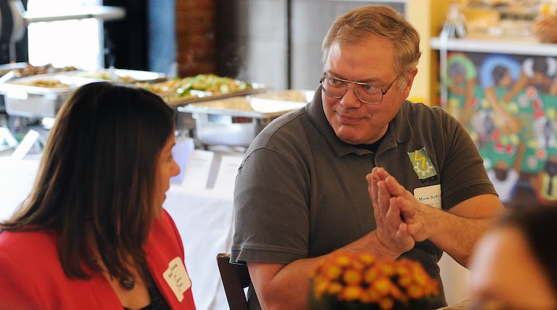 Mark DeBruin, of Skuld, LLC, right, talks with Andrea Kunk, of Peerless Technologies Corporation, at the Jobs Ohio and the Dayton Development Coalition luncheon at the West Social Tap and Table, Friday, Oct. 20, 2023. MARSHALL GORBY\STAFF