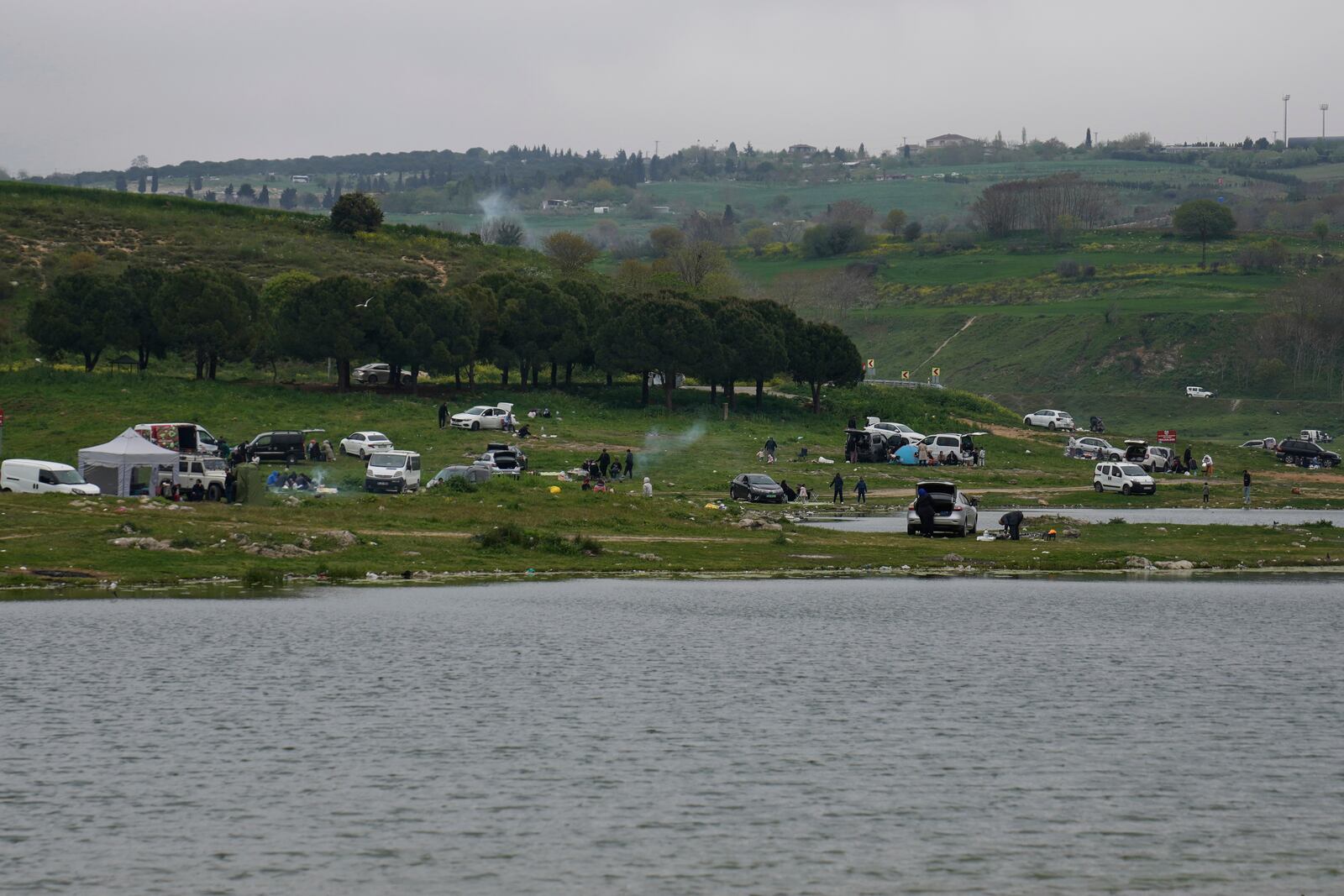 People gather outdoors away from urban areas following an earthquake shock with a preliminary magnitude of 6.2, in Istanbul, Turkey, Wednesday, April 23, 2025. (AP Photo/Khalil Hamra)