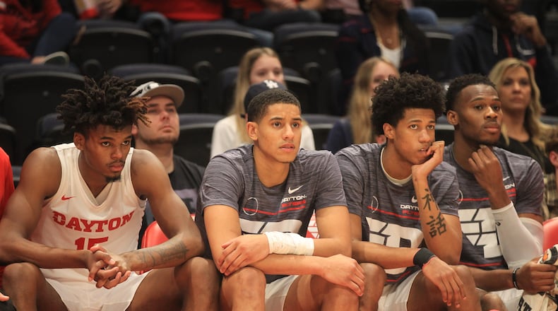 Dayton's DaRon Holmes II, Zimi Nwokeji, Kaleb Washington and Richard Amaefule watch the action during a game against Lipscomb on Wednesday, Nov. 17, 2021, at UD Arena. David Jablonski/Staf