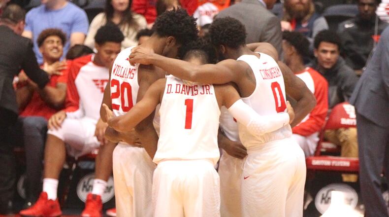 The Dayton Flyers huddle before a game against Ball State on Friday, Nov. 10, 2017, at UD Arena.