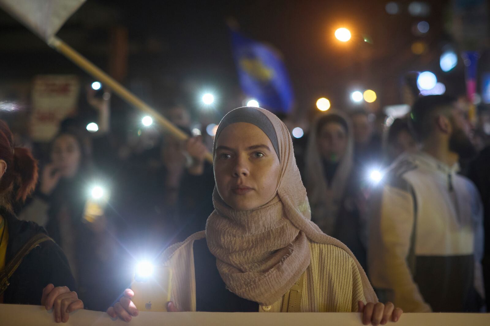 A student carries a banner during an anti-corruption protest in the southwestern town of Novi Pazar, Serbia, Friday, April 11, 2025. (AP Photo/Marko Drobnjakovic)