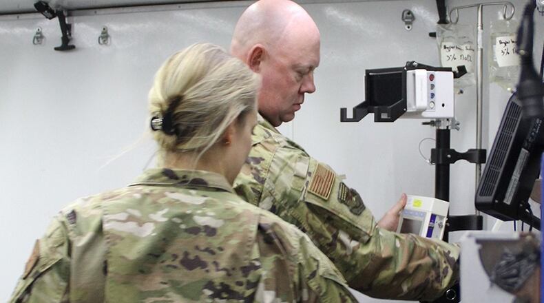 Maj. Kevin Smith, trauma nurse, 130th Medical Group, Charleston, West Virginia, Air National Guard; and Maj. Danielle Betz, emergency physician, 48th Medical Group, RAF Lakenheath, U.K. set up prototype B of the of the tactical anesthesia workstation for the first time April 8 during a Ground Surgical Team training course at U.S. Air Force School of Aerospace Medicine at Wright-Patterson Air Force Base. U.S. AIR FORCE PHOTO/ALEAH CASTREJON
