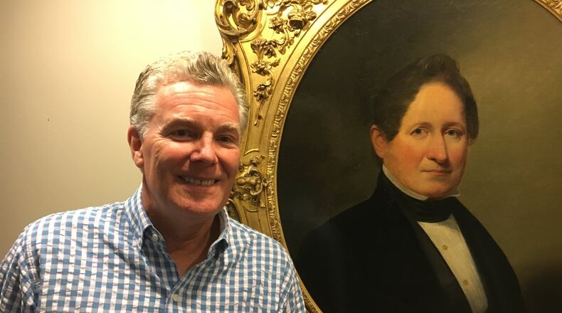 Charlie Simms, owner of Simms Development, keeps a portrait of his ancestor, Alexander Simms, in his office — a reminder that he’s a six-generation Daytonian. Simms has moved his business heavily into downtown residential development in recent years, and he sees that as a continuing trend. STAFF PHOTO/RON ROLLINS