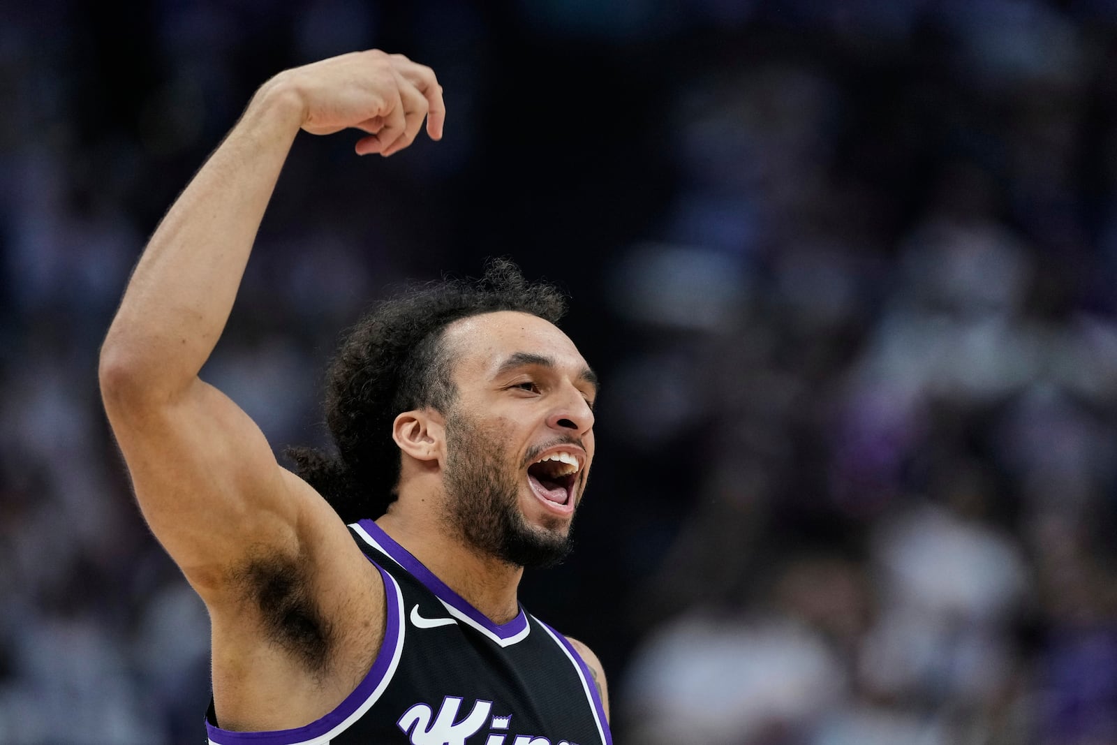 Sacramento Kings guard Devin Carter reacts after making a 3-point basket during the first half of an NBA play-in tournament basketball game against the Dallas Mavericks, Wednesday, April 16, 2025, in Sacramento, Calif. (AP Photo/Godofredo A. Vásquez)