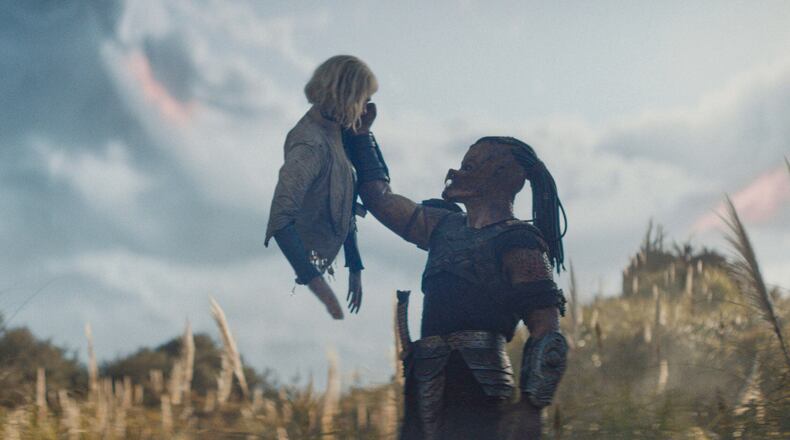 This image released by 20th Century Studios shows Thia, portrayed by Elle Fanning, left, and Dek, portrayed by Dimitrius Schuster-Koloamatangi, in a scene from "Predator: Badlands." (20th Century Studios/Disney via AP)